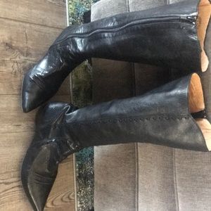 John Fluevog knee high black leather boots .